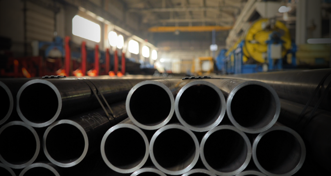 Picking up long pipes in a warehouse, for which Nolco RIB packaging is ideal to facilitate handling and protect the pipes in the best possible way.